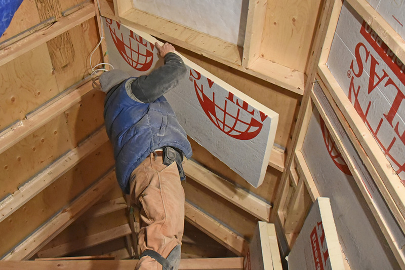EnergyShield polyiso insulation being installed in the Tiny Home.
